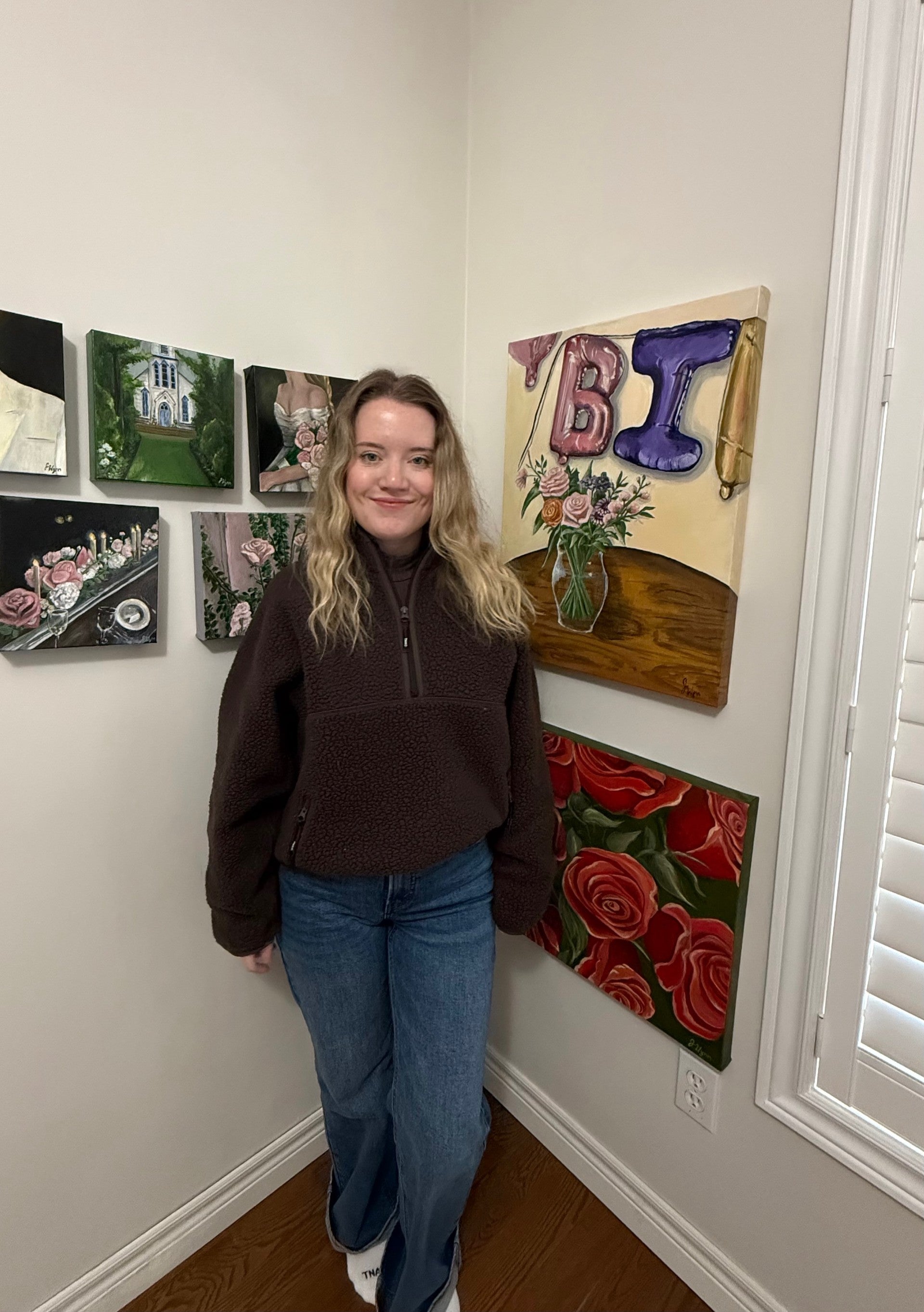 Person standing in a room with decorative wall art